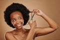 Haircut, scissors or happy black woman with afro in studio on brown background for positive change. Smile