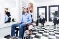 Haircutter cutting hair of customer Royalty Free Stock Photo