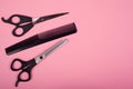 Haircutting tools on a pink background, copy space, straight and thinning shears with comb Royalty Free Stock Photo