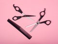 Haircutting tools, scissors and comb on a pink backgroundn Royalty Free Stock Photo
