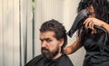 Hairdresser blow dry client male head in barbershop, hair care