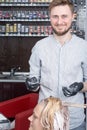 A hairdresser coloring hair of a blonde female client Royalty Free Stock Photo