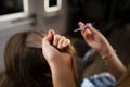 Hairdresser combing customer's hair at the hair salon Royalty Free Stock Photo