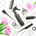 Hairdresser concept with spray, scissors, combs, barrette and tulips flowers on white background. Beauty feminine concept. Flat Royalty Free Stock Photo