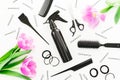 Hairdresser concept with spray, scissors, combs, barrette and tulips flowers on white background. Flat lay, top view Royalty Free Stock Photo