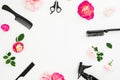 Hairdresser concept with spray, scissors, combs and roses flowers on white background. Beauty concept with copy space. Flat lay, t
