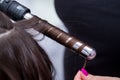 The hairdresser curl hair with figaro in the salon Royalty Free Stock Photo