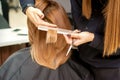 Hairdresser cuts hair to young woman Royalty Free Stock Photo