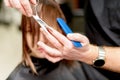 Hairdresser cuts hair of woman. Royalty Free Stock Photo