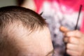 Hairdresser cuts man`s hair. Men`s haircut Royalty Free Stock Photo