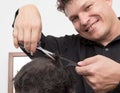 Hairdresser cuts men`s hair cut Royalty Free Stock Photo