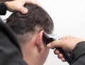 Hairdresser cuts men`s hair cut Royalty Free Stock Photo