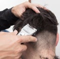 Hairdresser cuts men`s hair cut Royalty Free Stock Photo