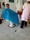 hairdresser cutting in beauty saloon