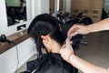 Hairdresser cutting client`s hair in salon with scissors closeup. Using a comb Royalty Free Stock Photo