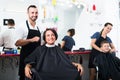 Hairdresser cutting hair of female client. Royalty Free Stock Photo