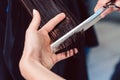 Hairdresser cutting and styling hair of woman in her shop Royalty Free Stock Photo