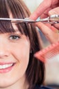 Hairdresser cutting woman bangs hair Royalty Free Stock Photo