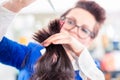 Hairdresser cutting woman hair in shop Royalty Free Stock Photo