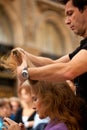 Hairdresser cutting woman`s hair