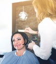 Hairdresser does to woman haircut with use of scissors and hairbrushes Royalty Free Stock Photo