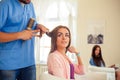 Hairdresser doing haircut for women in hairdressing salon. Concept of fashion and beauty. Positive emotion. Royalty Free Stock Photo