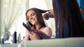 Hairdresser doing haircut for women in hairdressing salon. Concept of fashion and beauty. Positive emotion Royalty Free Stock Photo