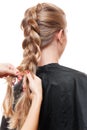 Hairdresser doing up one's hair in a plait