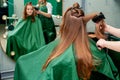 Hairdresser dries hair of woman