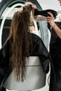 Hairdresser drying hair of woman Royalty Free Stock Photo