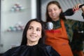 Hairdresser drying hair woman client in hairdressing beauty salon Royalty Free Stock Photo