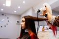 Hairdresser drying woman hair with hairdryer Royalty Free Stock Photo