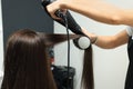 Hairdresser drying woman`s hair in beauty salon, closeup Royalty Free Stock Photo