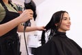 Hairdresser drying woman`s hair in beauty salon, closeup Royalty Free Stock Photo