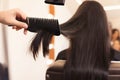 Hairdresser drying woman`s hair in beauty salon, closeup Royalty Free Stock Photo