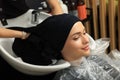 Hairdresser drying woman`s hair with towel in beauty salon Royalty Free Stock Photo