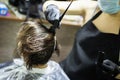 Hairdresser dyes woman hair