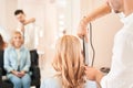 Hairdresser getting hair done with curling iron Royalty Free Stock Photo