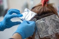 Hairdresser in a hair dyeing process