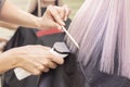 Hairdresser with a hair machine. cutting off split ends of hair with a clipper. close up. blonde hair Royalty Free Stock Photo