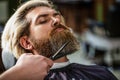 Hairdresser, hair salon. Bearded man. Barber scissors, barber shop. Vintage barbershop, shaving. Man hairstylist. Beard Royalty Free Stock Photo