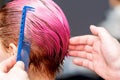 Hairdresser hand combing hair. Royalty Free Stock Photo