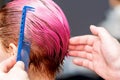 Hairdresser`s hand combing hair of woman Royalty Free Stock Photo