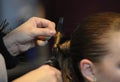 Hairdresser hands doing woman client hair, hairdressing salon.