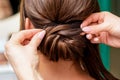 Hairdresser hands making hairstyle.