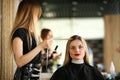 Hairdresser Holding Long Hair Strand of Client Royalty Free Stock Photo