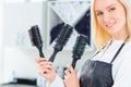 Hairdresser holding several hairbrushes