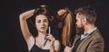 Hairdresser makes hair style with hair care products. Hairdresser making hairstyle, haircut. Woman with long hair at Royalty Free Stock Photo