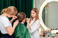 Hairdresser and makeup artist work in tandem. Royalty Free Stock Photo