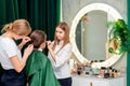 Hairdresser and makeup artist work in tandem Royalty Free Stock Photo